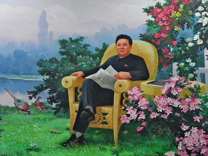 Kim Jong Il sentado en un jardin